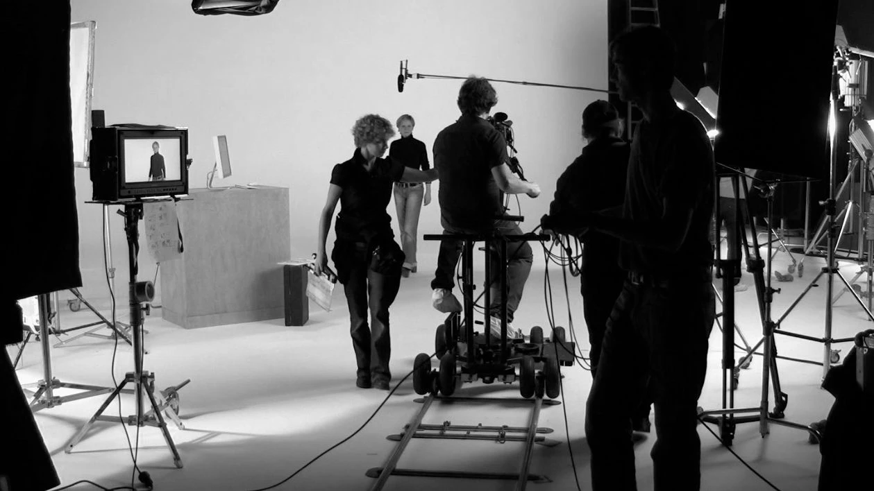 Film crew working on movie set with camera and lighting equipment